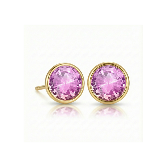 Gold earrings with  colorful pink gemstones on a white background