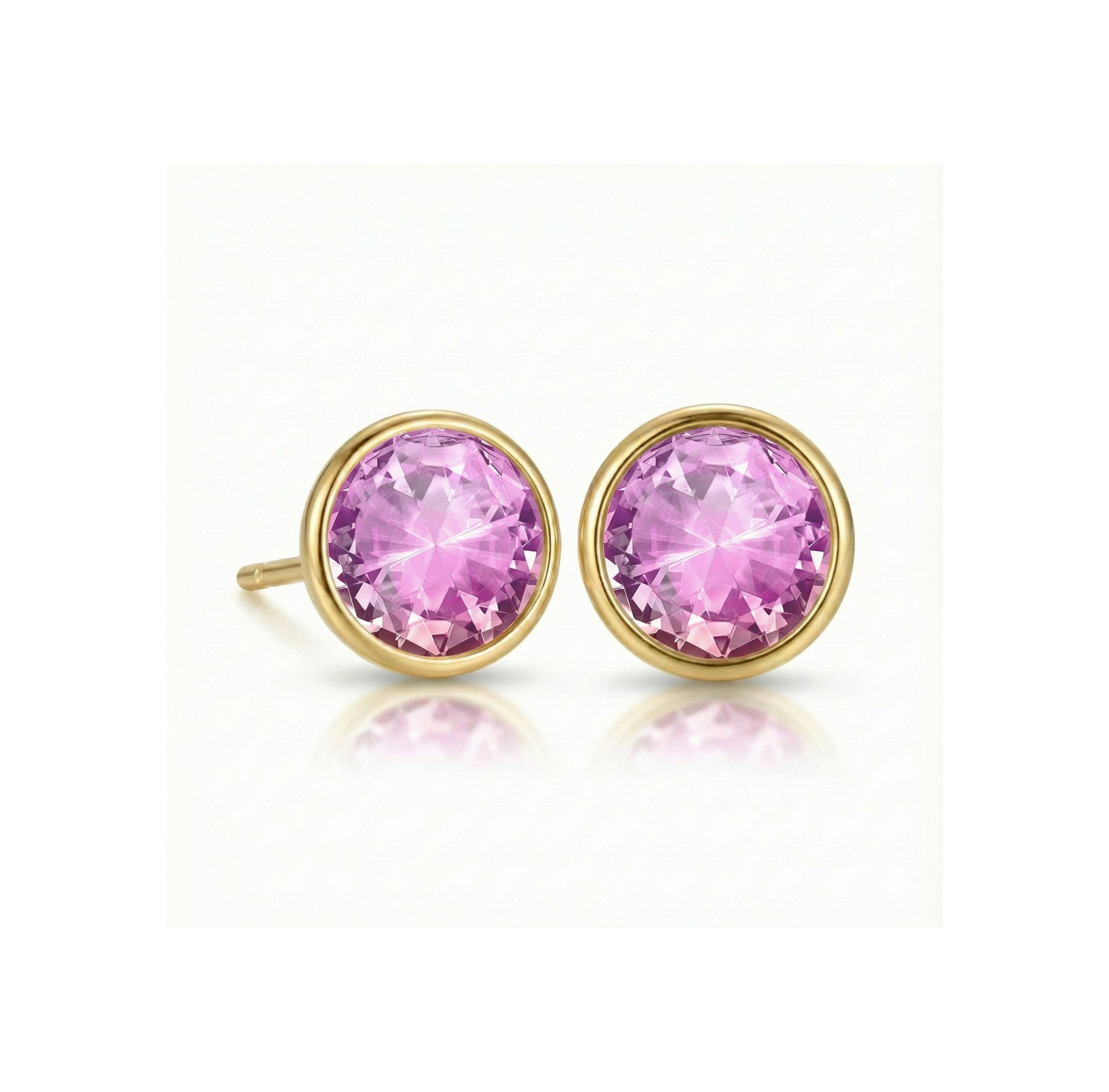 Gold earrings with  colorful pink gemstones on a white background