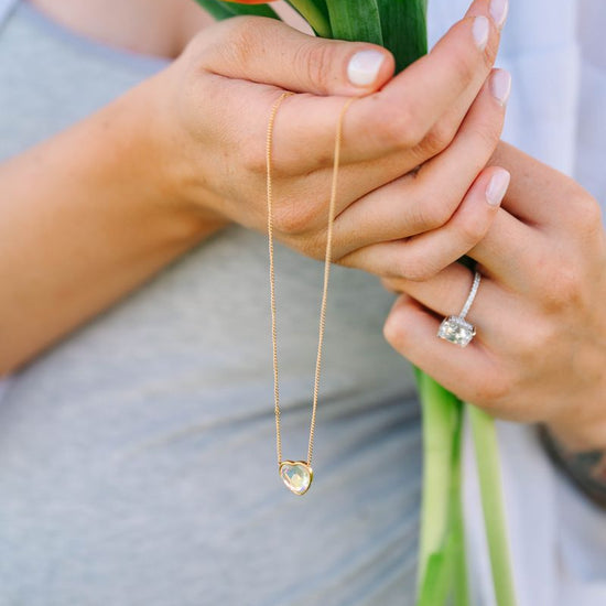 Heart Crystal Necklace, a stunning symbol of love and elegance. This beautiful necklace features a radiant heart-shaped crystal, surrounded by a delicate halo of smaller crystals that enhance its brilliance. Designed to capture and reflect light, this necklace creates a sparkling effect that adds a touch of glamour to any outfit.
