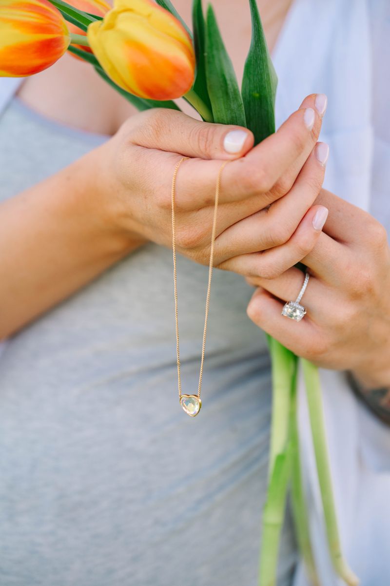 Heart Crystal Necklace, a stunning symbol of love and elegance. This beautiful necklace features a radiant heart-shaped crystal, surrounded by a delicate halo of smaller crystals that enhance its brilliance. Designed to capture and reflect light, this necklace creates a sparkling effect that adds a touch of glamour to any outfit.