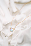 Heart Crystal Necklace, a stunning symbol of love and elegance. This beautiful necklace features a radiant heart-shaped crystal, surrounded by a delicate halo of smaller crystals that enhance its brilliance. Designed to capture and reflect light, this necklace creates a sparkling effect that adds a touch of glamour to any outfit.