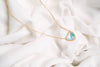Heart Crystal Necklace, a stunning symbol of love and elegance. This beautiful necklace features a radiant heart-shaped crystal, surrounded by a delicate halo of smaller crystals that enhance its brilliance. Designed to capture and reflect light, this necklace creates a sparkling effect that adds a touch of glamour to any outfit.