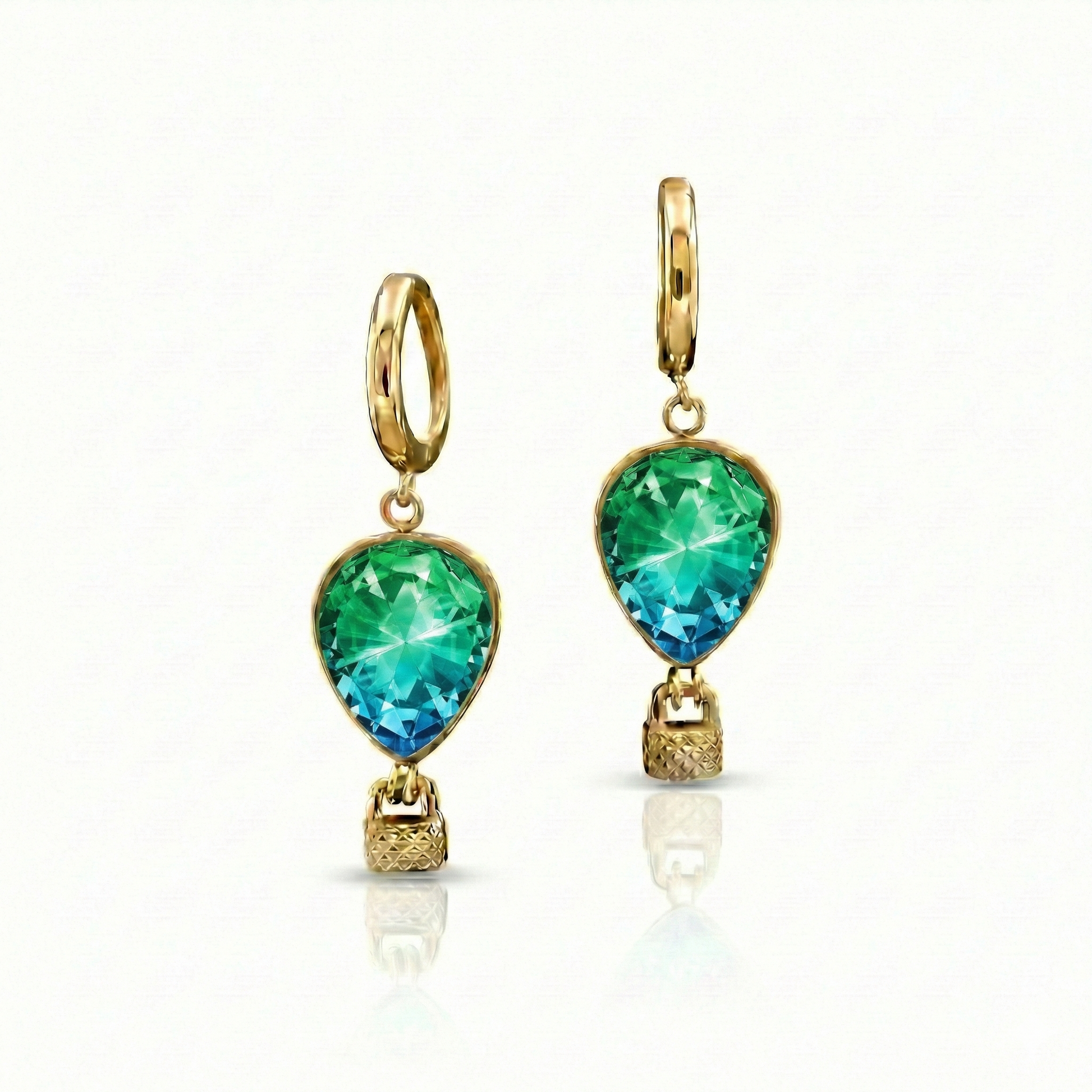 Gold earrings with green gemstones featuring delicate hot air balloon charms