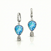 Pair of earrings with blue teardrop-shaped gemstones featuring delicate hot air balloon charms