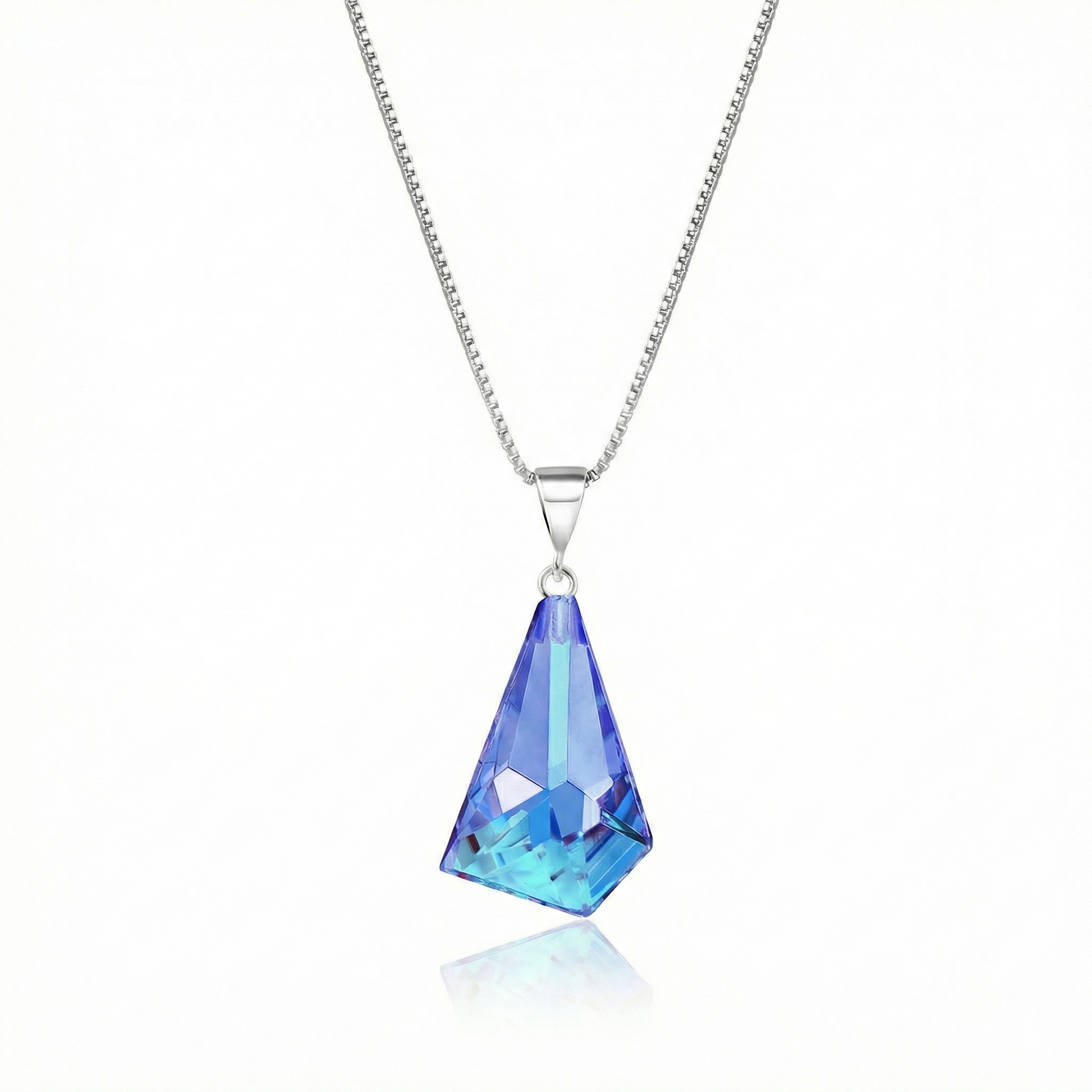  Iridescent Geometric Pendant Inspired by the unique form of sublime glaciers. Crafted with high-quality sterling silver components, this polished blue stone pendant comes with an included 18" sterling silver .7mm box chain for a polished look.