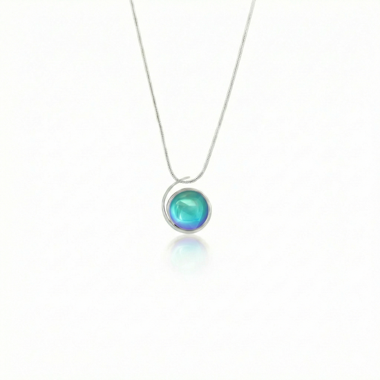 Large Sterling Silver Crystal Wave Pendant where it represents the "O" of Ocean Beach, while the surrounding silver symbolizes the "B." Crafted with .925 sterling silver components, the pendant comes with a 1mm sterling silver snake chain, 18" long with a polished aqua stone.