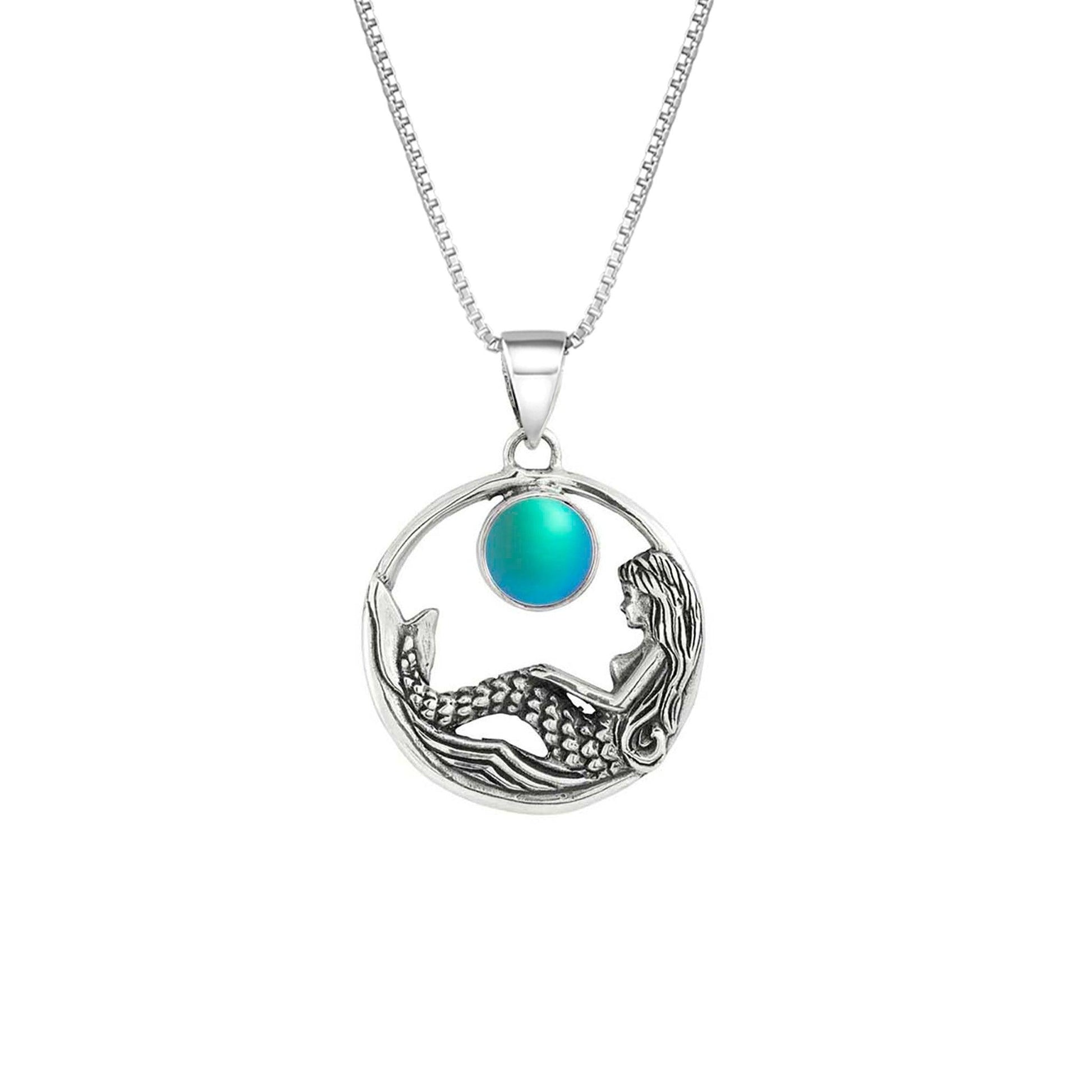 Mermaid Pendant features a beautiful mermaid sitting gracefully beneath a stunning 9mm glowing, frosted aqua crystal. The pendant comes with an 18" sterling silver .7mm box chain included.