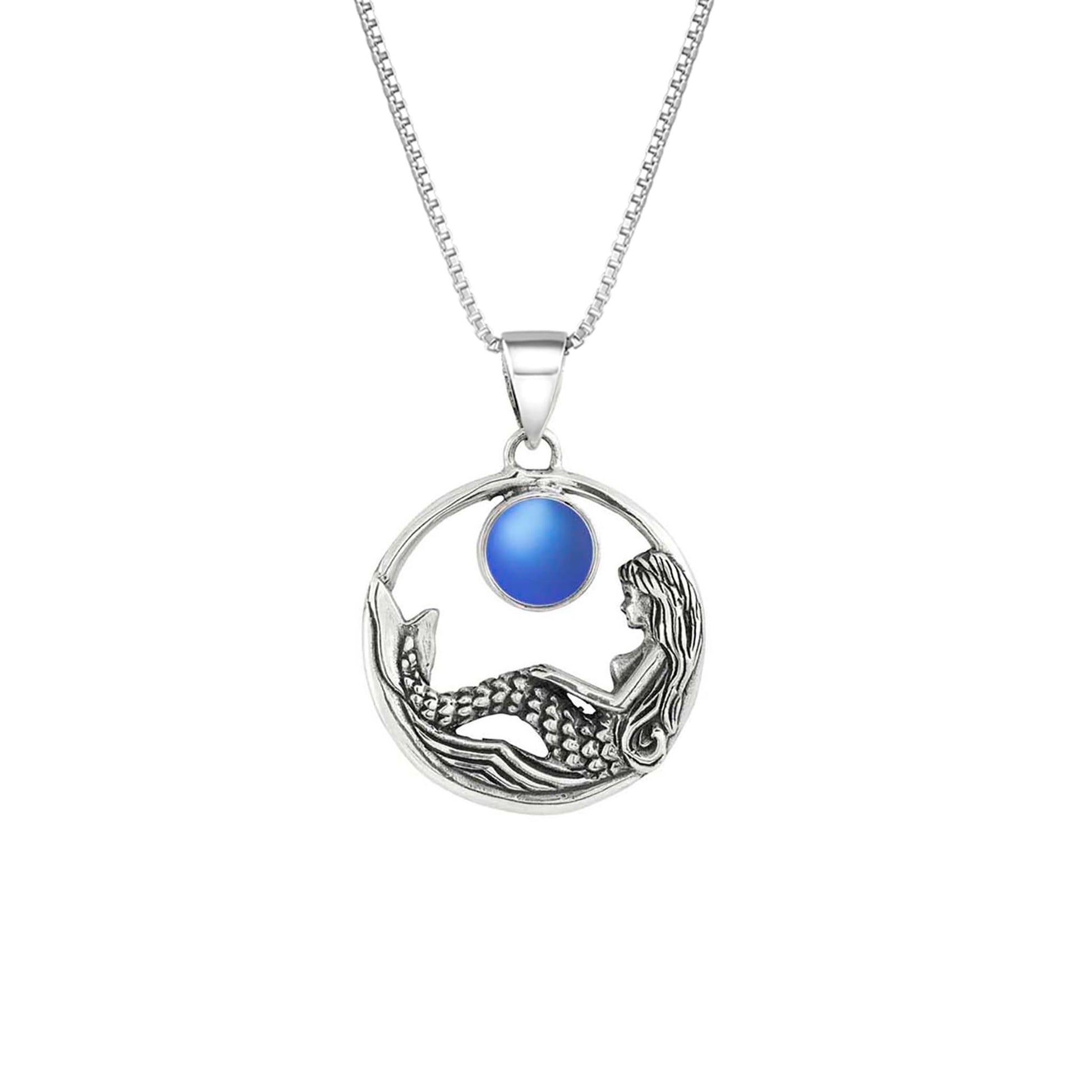 Mermaid Pendant features a beautiful mermaid sitting gracefully beneath a stunning 9mm glowing, frosted blue crystal. The pendant comes with an 18" sterling silver .7mm box chain included.