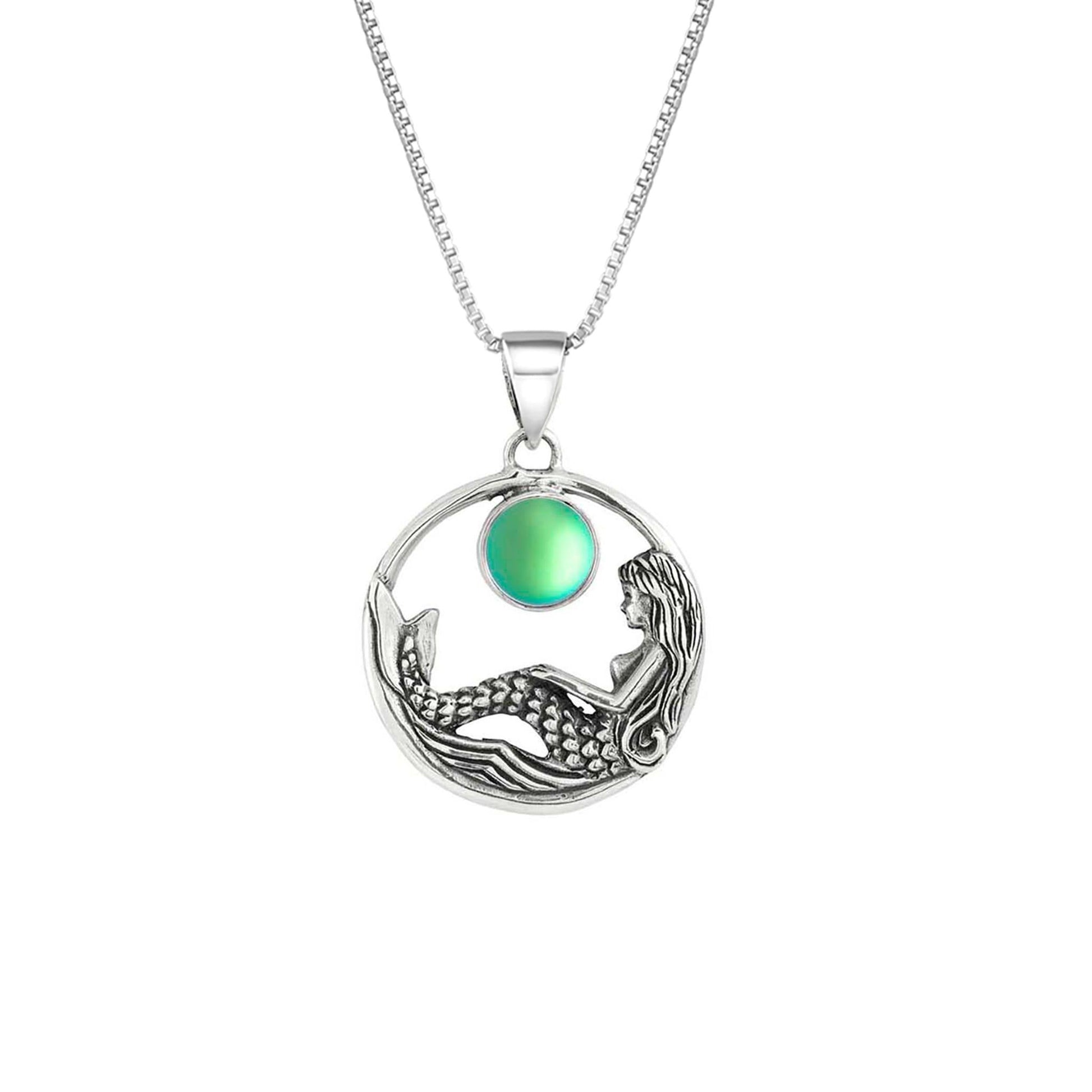 Mermaid Pendant features a beautiful mermaid sitting gracefully beneath a stunning 9mm glowing, frosted green crystal. The pendant comes with an 18" sterling silver .7mm box chain included.