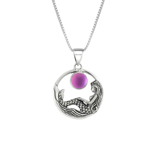 Mermaid Pendant features a beautiful mermaid sitting gracefully beneath a stunning 9mm glowing, frosted pink crystal. The pendant comes with an 18" sterling silver .7mm box chain included.
