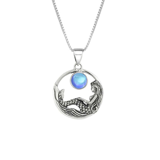 Mermaid Pendant features a beautiful mermaid sitting gracefully beneath a stunning 9mm glowing, polished blue crystal. The pendant comes with an 18" sterling silver .7mm box chain included.