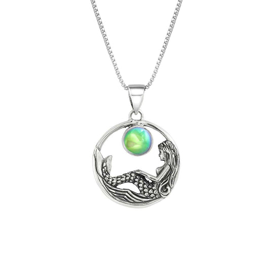 Mermaid Pendant features a beautiful mermaid sitting gracefully beneath a stunning 9mm glowing, polished green crystal. The pendant comes with an 18" sterling silver .7mm box chain included.