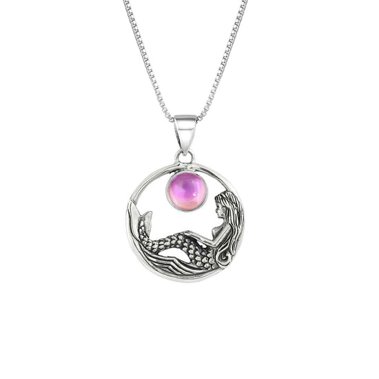 Mermaid Pendant features a beautiful mermaid sitting gracefully beneath a stunning 9mm glowing, polished pink crystal. The pendant comes with an 18" sterling silver .7mm box chain included.
