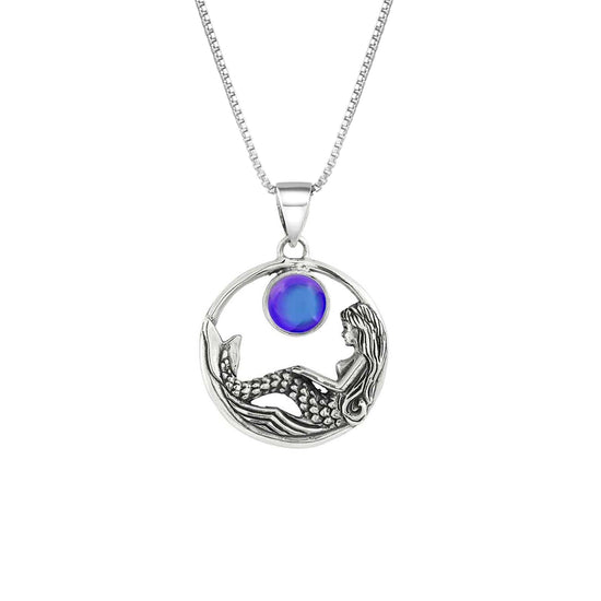 Mermaid Pendant features a beautiful mermaid sitting gracefully beneath a stunning 9mm glowing, polished violet crystal. The pendant comes with an 18" sterling silver .7mm box chain included.