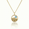 Gold necklace with a moose, mountain, and blue gem pendant.
