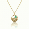 Gold necklace with a moose walking in medow, mountain, and green gem pendant.