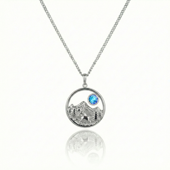 Silver necklace with a moose, mountain, and blue gem pendant.