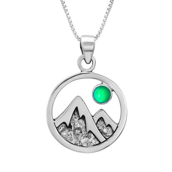 Mountain Pendant featuring a beautiful depiction of mountains under the moon or sun, this pendant captures the serene beauty of nature. The frosted green pendant includes an 18" sterling silver .7mm box chain.