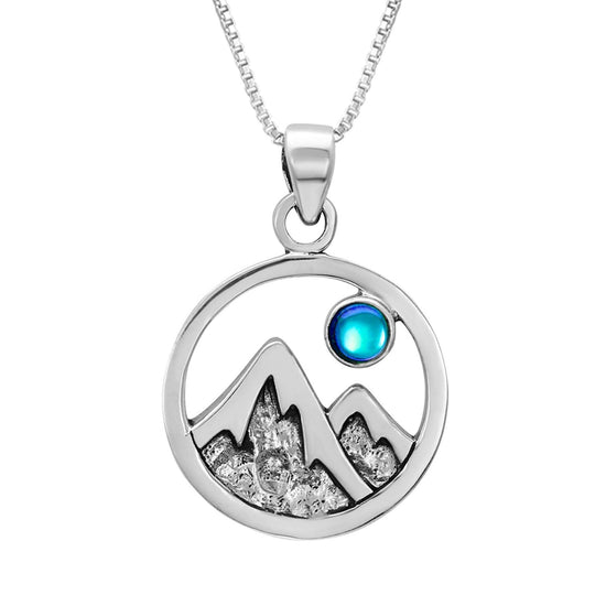 Mountain Pendant featuring a beautiful depiction of mountains under the moon or sun, this pendant captures the serene beauty of nature. The polished blue pendant includes an 18" sterling silver .7mm box chain.