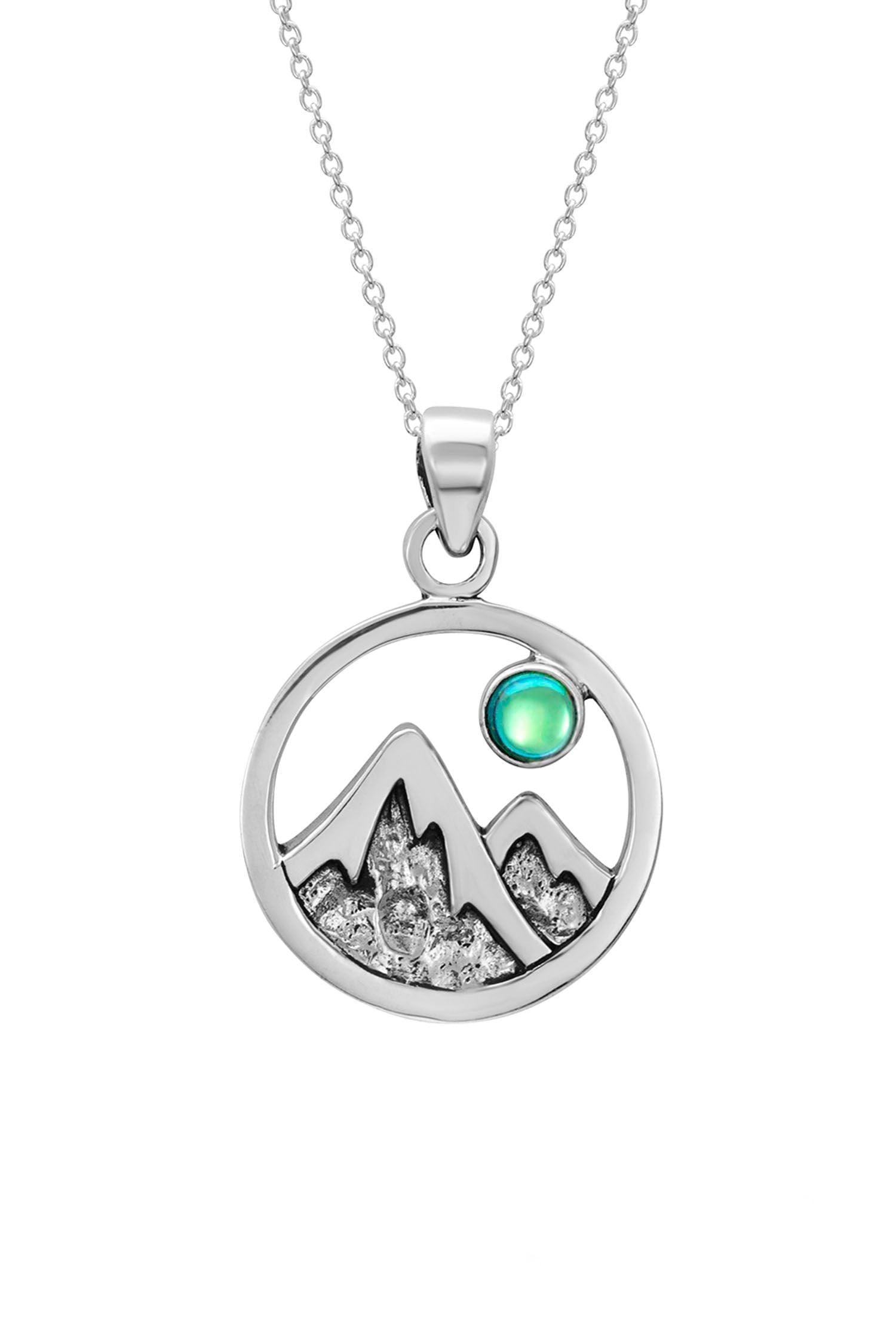 Mountain Pendant featuring a beautiful depiction of mountains under the moon or sun, this pendant captures the serene beauty of nature. The polished green pendant includes an 18" sterling silver .7mm box chain.