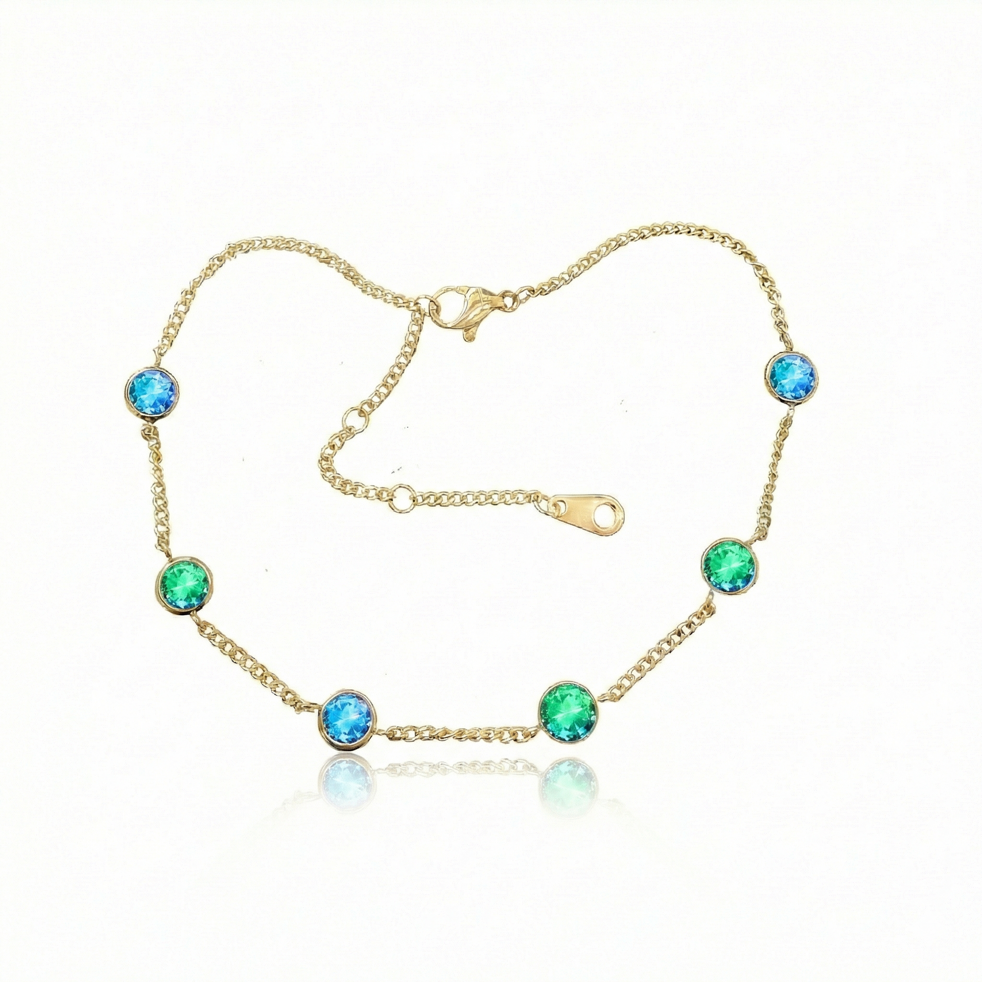 Multi Stone Bracelet features reversible 5mm blue and green stones set in 18k gold PVD-coated chain. An adjustable sizing range of 6" to 7" accommodates most wrist sizes comfortably.