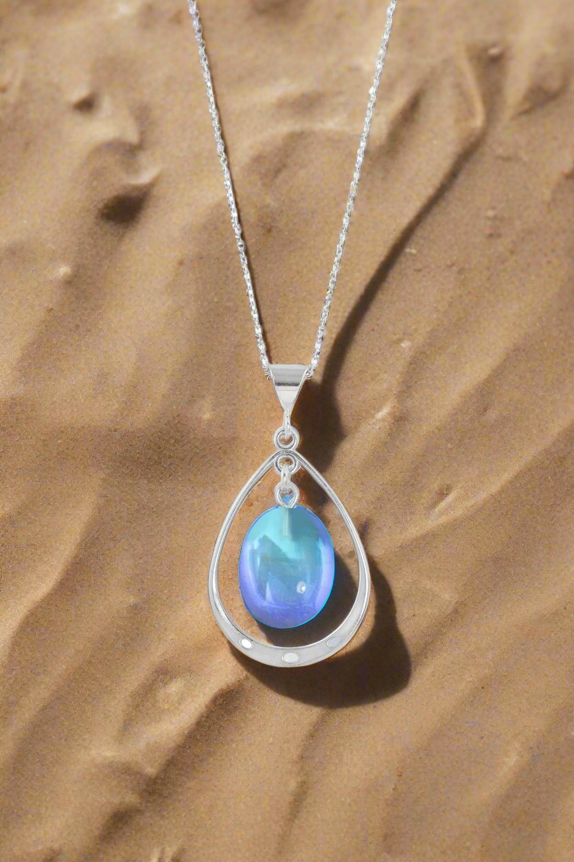 Oval with Loop Pendant handmade pendant pairs beautifully with any outfit, and you’ll love how the polished blue crystal oval shines with an iridescent glow of color from within. The pendant comes with an 18" sterling silver .7mm box chain included.