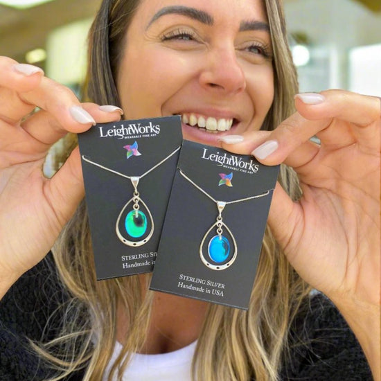 Oval with Loop Pendant handmade pendant pairs beautifully with any outfit, and you’ll love how the crystal oval shines with an iridescent glow of color from within. The pendant comes with an 18" sterling silver .7mm box chain included.