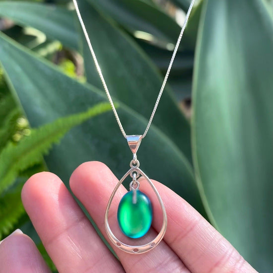Oval with Loop Pendant handmade pendant pairs beautifully with any outfit, and you’ll love how the  frosted green crystal oval shines with an iridescent glow of color from within. The pendant comes with an 18" sterling silver .7mm box chain included.