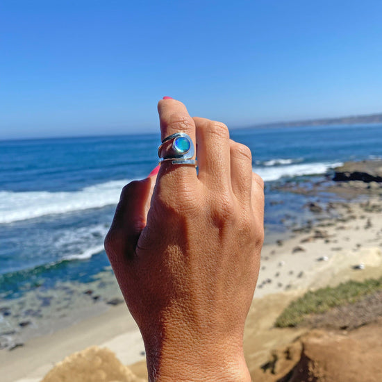 Raima Ring features a design that is not symmetrical, yet beautifully balanced. Crafted from sturdy sterling silver with polished blue stone, this ring is adjustable, allowing you to customize the fit starting at size 7.5.