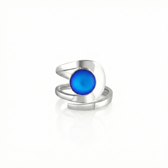 Raima Ring features a design that is not symmetrical, yet beautifully balanced. Its airy and light aesthetic brilliantly showcases the sparkling, frosted blue crystal at its center. Crafted from sturdy sterling silver, this ring is adjustable, allowing you to customize the fit starting at size 7.5.