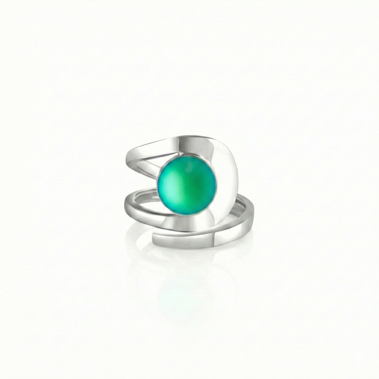 Raima Ring features a design that is not symmetrical, yet beautifully balanced. Its airy and light aesthetic brilliantly showcases the sparkling, frosted green crystal at its center. Crafted from sturdy sterling silver, this ring is adjustable, allowing you to customize the fit starting at size 7.5.
