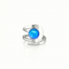 Raima Ring features a design that is not symmetrical, yet beautifully balanced. Its airy and light aesthetic brilliantly showcases the sparkling, polished blue crystal at its center. Crafted from sturdy sterling silver, this ring is adjustable, allowing you to customize the fit starting at size 7.5.