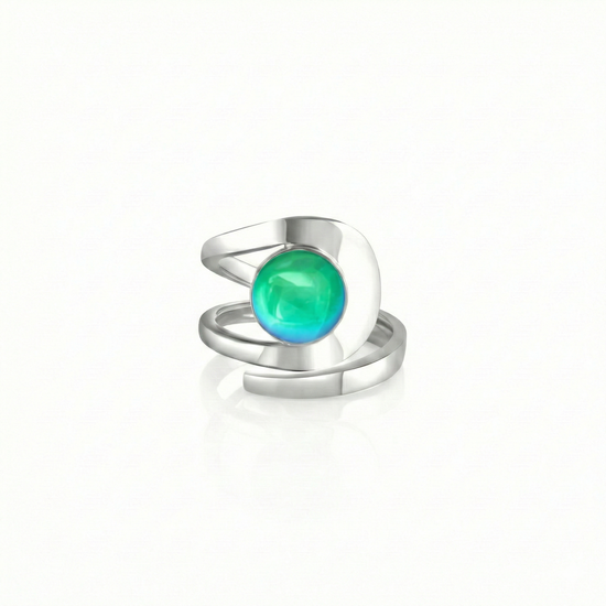Raima Ring features a design that is not symmetrical, yet beautifully balanced. Its airy and light aesthetic brilliantly showcases the sparkling, polished green crystal at its center. Crafted from sturdy sterling silver, this ring is adjustable, allowing you to customize the fit starting at size 7.5.