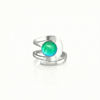 Raima Ring features a design that is not symmetrical, yet beautifully balanced. Its airy and light aesthetic brilliantly showcases the sparkling, polished green crystal at its center. Crafted from sturdy sterling silver, this ring is adjustable, allowing you to customize the fit starting at size 7.5.