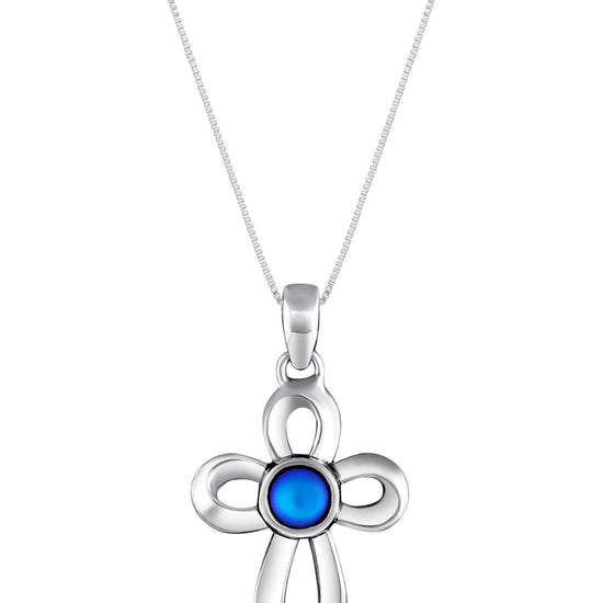 Ribbon Cross Pendant features a beautifully crafted design that adds a touch of elegance to the traditional cross, creating an eye-catching look.  At the center, our signature color-changing frosted blue crystal beautifully enhances this classic religious symbol. These earrings are crafted from high-quality sterling silver, ensuring durability and shine. 
