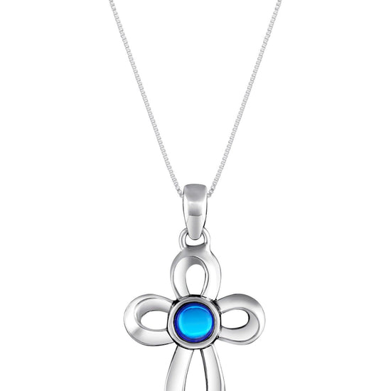 Ribbon Cross Pendant features a beautifully crafted design that adds a touch of elegance to the traditional cross, creating an eye-catching look.  At the center, our signature color-changing polished blue crystal beautifully enhances this classic religious symbol. These earrings are crafted from high-quality sterling silver, ensuring durability and shine. 