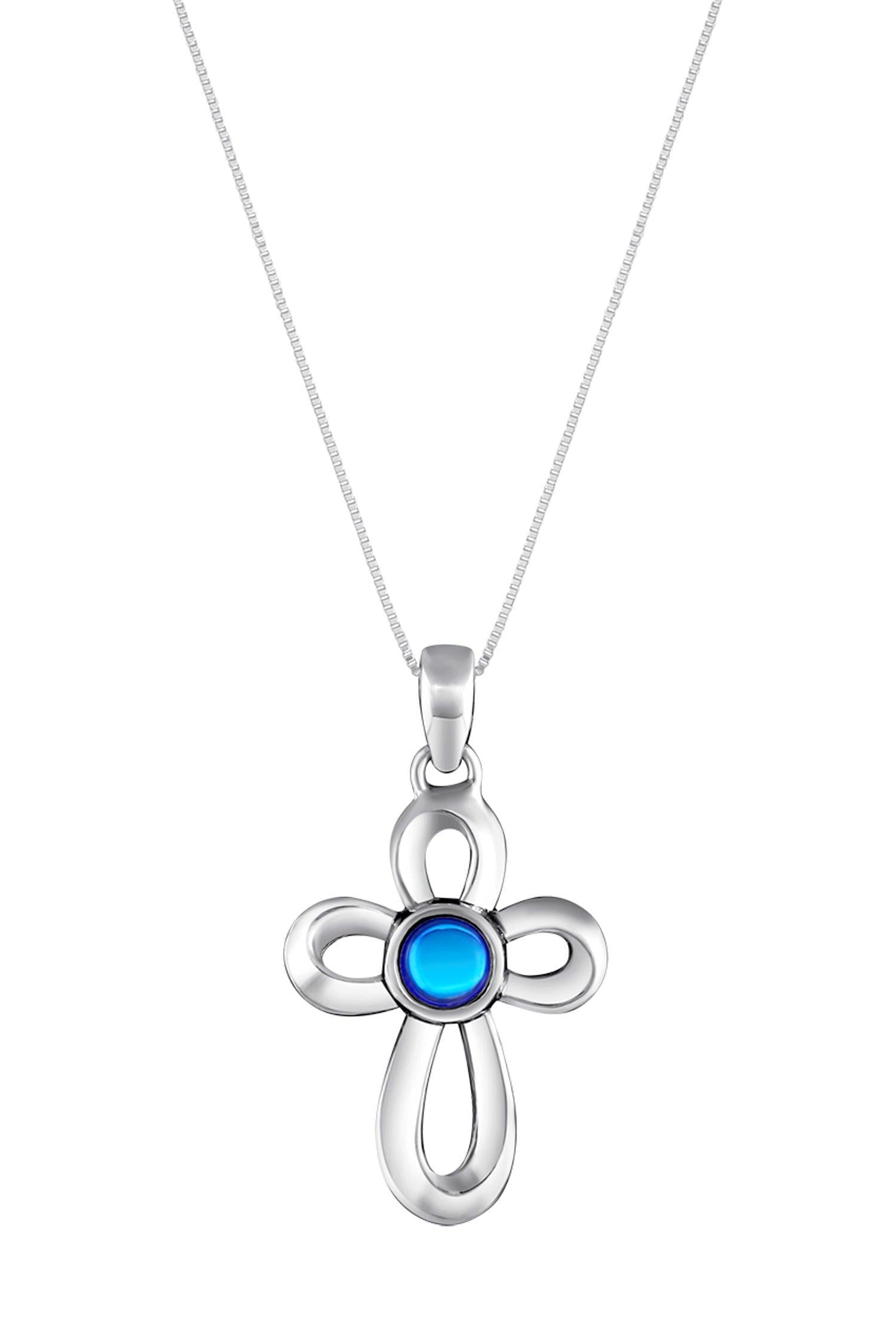 Ribbon Cross Pendant features a beautifully crafted design that adds a touch of elegance to the traditional cross, creating an eye-catching look.  At the center, our signature color-changing polished blue crystal beautifully enhances this classic religious symbol. These earrings are crafted from high-quality sterling silver, ensuring durability and shine. 