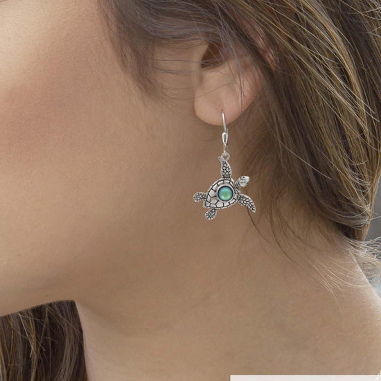Sea Turtle Earrings, inspired by the Hawaiian Turtle, known as Honu. Crafted from sterling silver, these earrings with frosted green stone beautifully showcase your love for the ocean.
