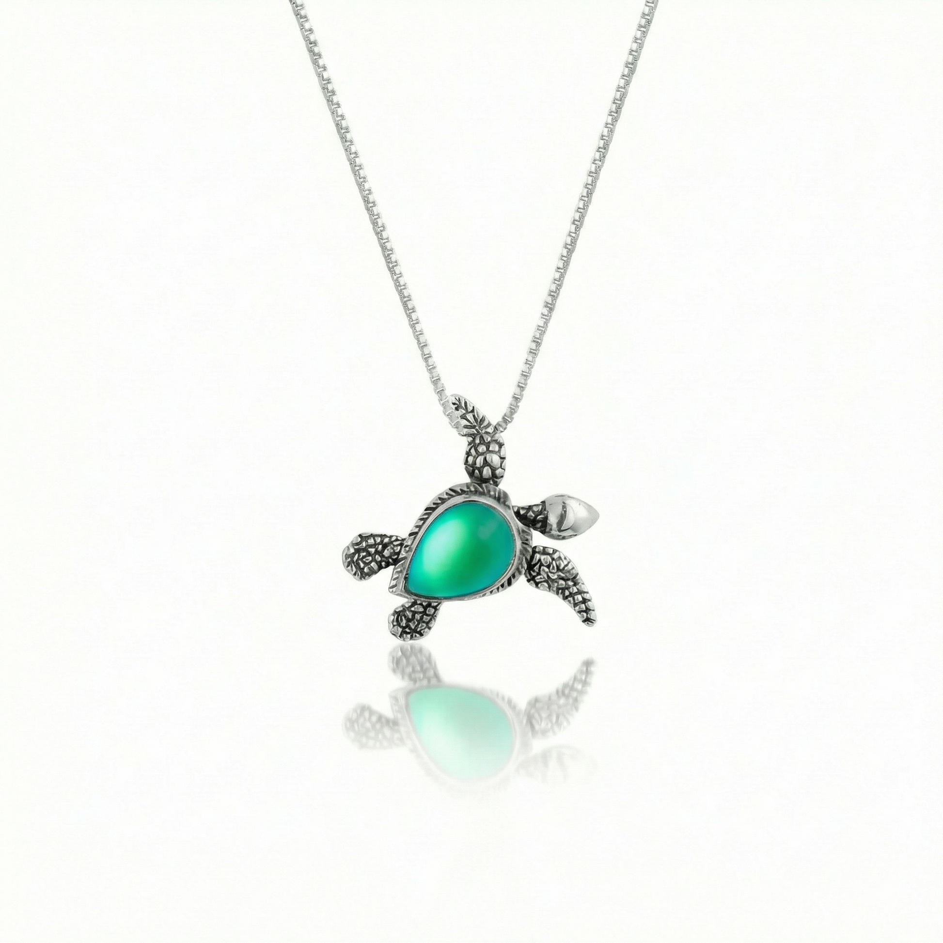 Sideways Sea Turtle Pendant brings wisdom and good luck that comes with an 18" sterling silver and a frosted green stone.