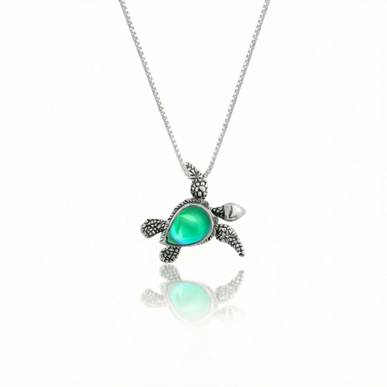 Sideways Sea Turtle Pendant brings wisdom and good luck that comes with an 18" sterling silver and a polished green stone.