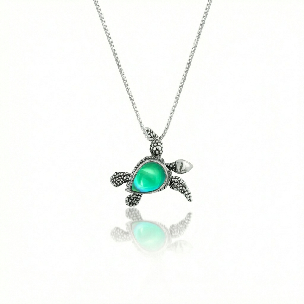 Sideways Sea Turtle Pendant brings wisdom and good luck that comes with an 18" sterling silver and a polished green stone.