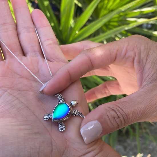 Sideways Sea Turtle Pendant inspired by the Hawaiian Green Turtle, known as Honu. This charming frosted blue pendant features moveable elements for the turtle's head, arms, legs, and tail. The pendant comes with an 18" sterling silver .7mm box chain included.