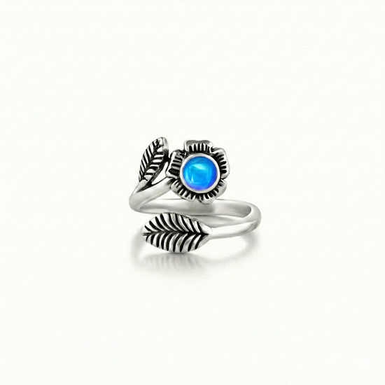 Silver Flower Adjustable Ring is a stunning piece that beautifully showcases a 5mm polished blue stone at its center. 