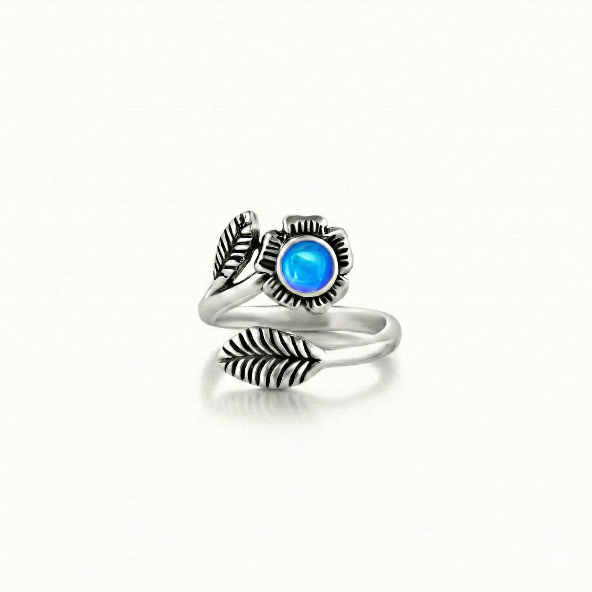 Silver Flower Adjustable Ring is a stunning piece that beautifully showcases a 5mm polished blue stone at its center. 