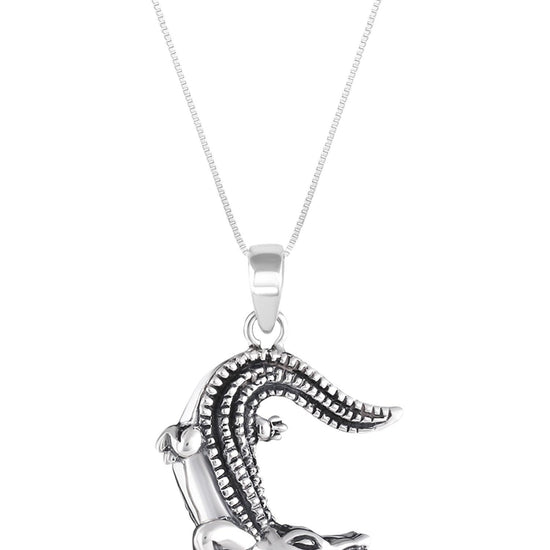 Small Gator Pendant, custom-made for Gatorland in Florida, this pendant showcases a unique design that captures the spirit of the iconic alligator. Featuring a stunning 5mm frosted blue stone set in solid .925 sterling silver.
