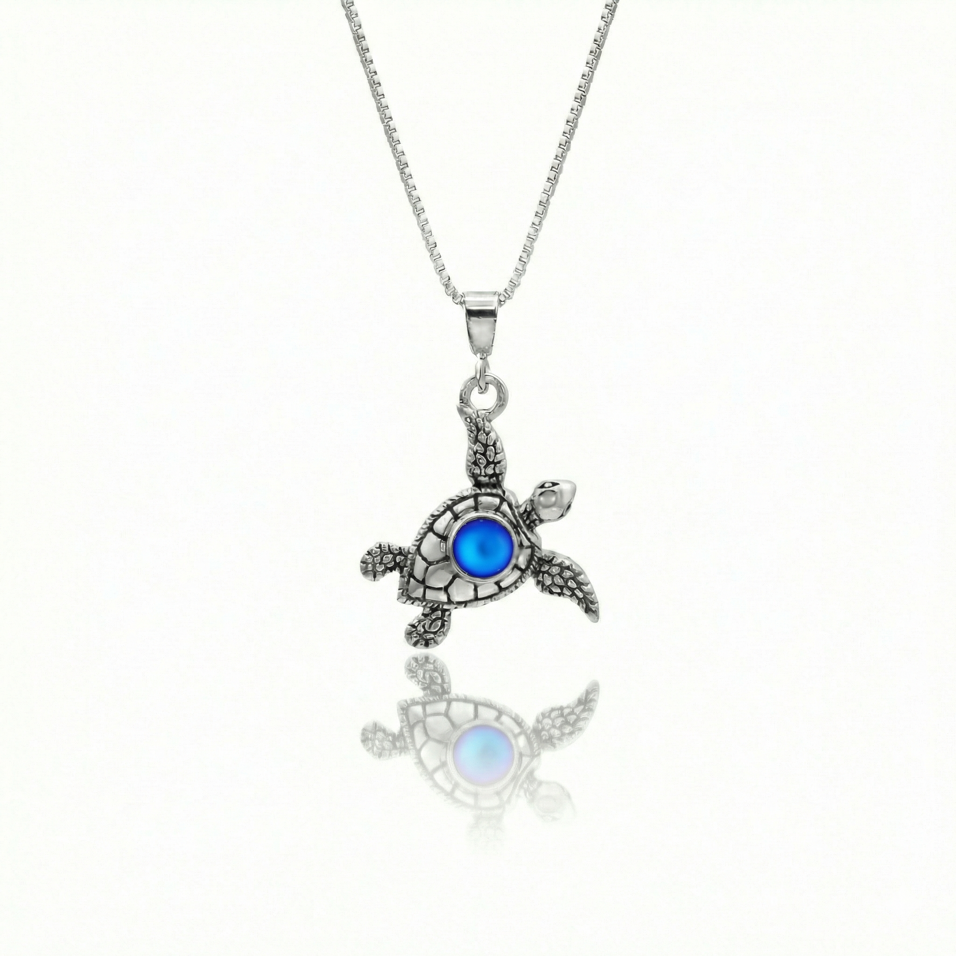 Small Turtle Pendant featuring a charming design, this pendant is adorned with a 5mm frosted blue stone that adds a touch of sparkle. It comes with an 18" .7mm sterling silver box chain, ensuring it’s ready to wear right away.