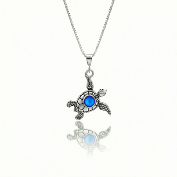 Small Turtle Pendant featuring a charming design, this pendant is adorned with a 5mm frosted blue stone that adds a touch of sparkle. It comes with an 18" .7mm sterling silver box chain, ensuring it’s ready to wear right away.