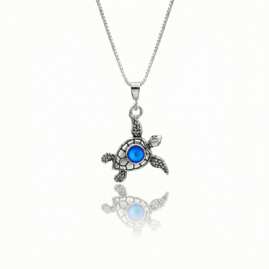 Small Turtle Pendant featuring a charming design, this pendant is adorned with a 5mm frosted blue stone that adds a touch of sparkle. It comes with an 18" .7mm sterling silver box chain, ensuring it’s ready to wear right away.