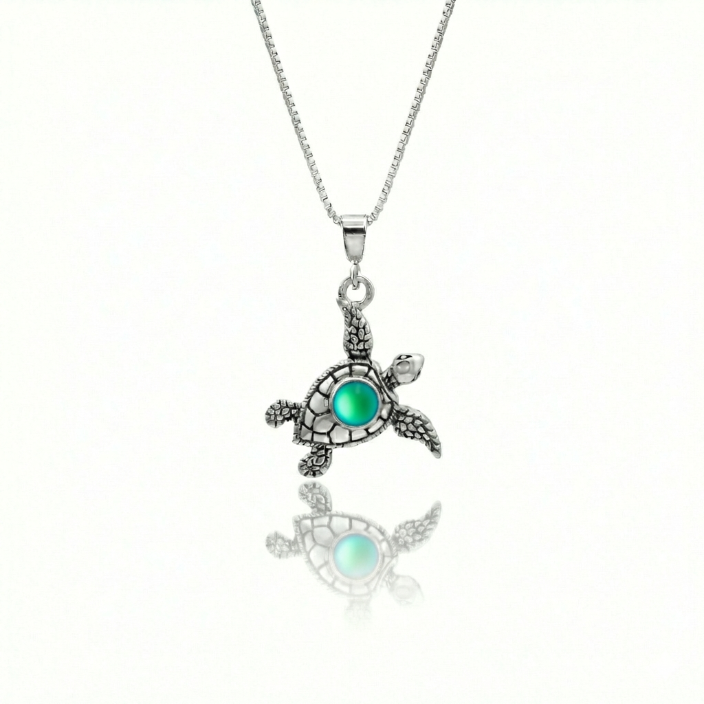 Small Turtle Pendant featuring a charming design, this pendant is adorned with a 5mm frosted green stone that adds a touch of sparkle. It comes with an 18" .7mm sterling silver box chain, ensuring it’s ready to wear right away.