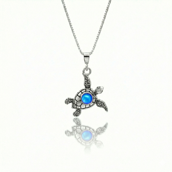 Small Turtle Pendant featuring a charming design, this pendant is adorned with a 5mm polished blue stone that adds a touch of sparkle. It comes with an 18" .7mm sterling silver box chain, ensuring it’s ready to wear right away.